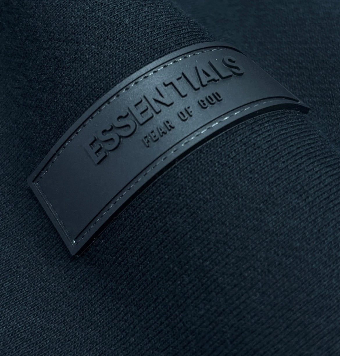 close up stitching and logos of essential